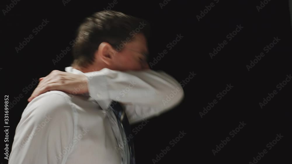 CORONAVIRUS: Businessman sneezing into a hand CORONAVIRUS: Businessman sneezing into a hand