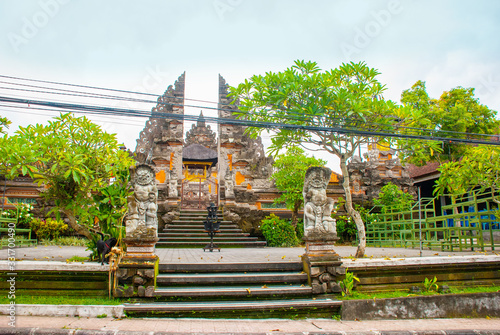 UBUD, BALI, INDONESIA - APRIL 2017: Beautiful Balinese entrance gate of the temple, a Pura Pusen temple in the center of Ubud, Bali, Indonesia. photo