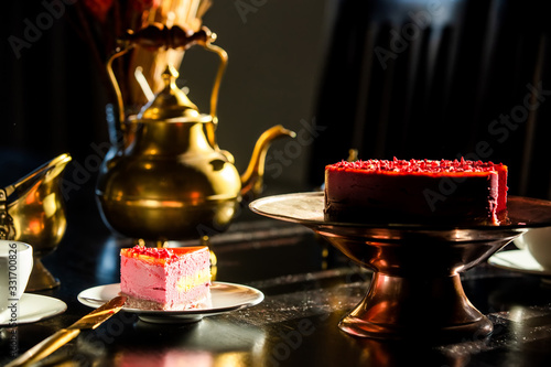 Fototapeta Naklejka Na Ścianę i Meble -  Teapot, cup and raw cherry cake on a table