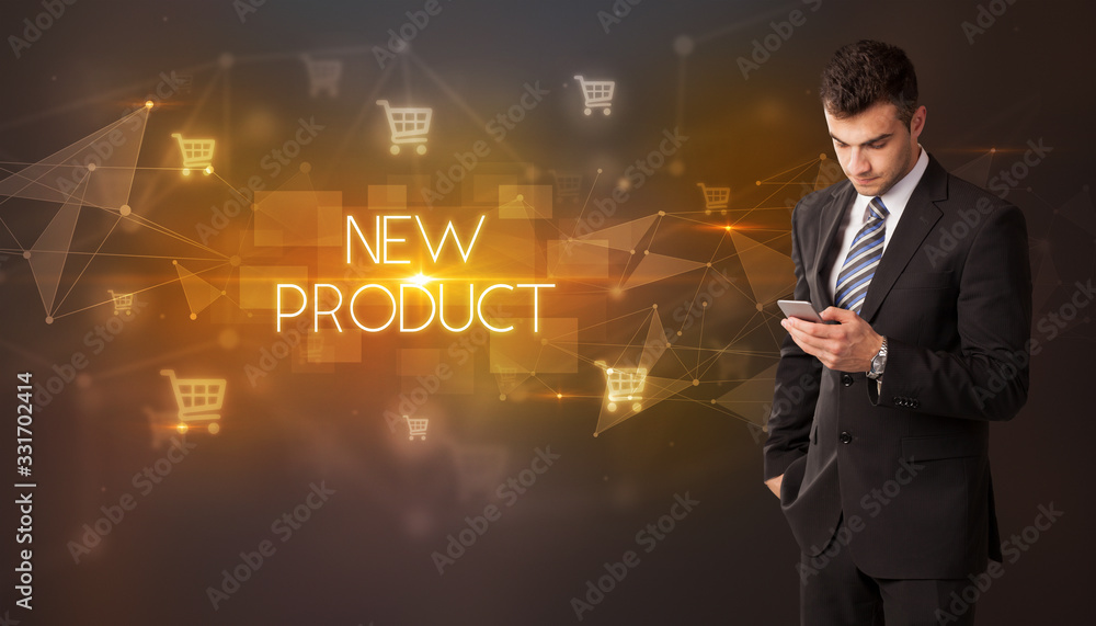 Businessman with shopping cart icons and NEW PRODUCT inscription, online shopping concept Businessman with shopping cart icons and NEW PRODUCT inscription, online shopping concept