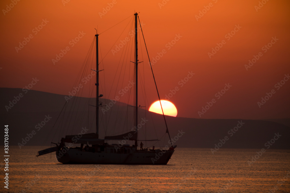 Alyko beach, Naxos / Greece - August 23, 2014: Sunset at Alyko beach in Naxos, Cyclades Islands, Greece