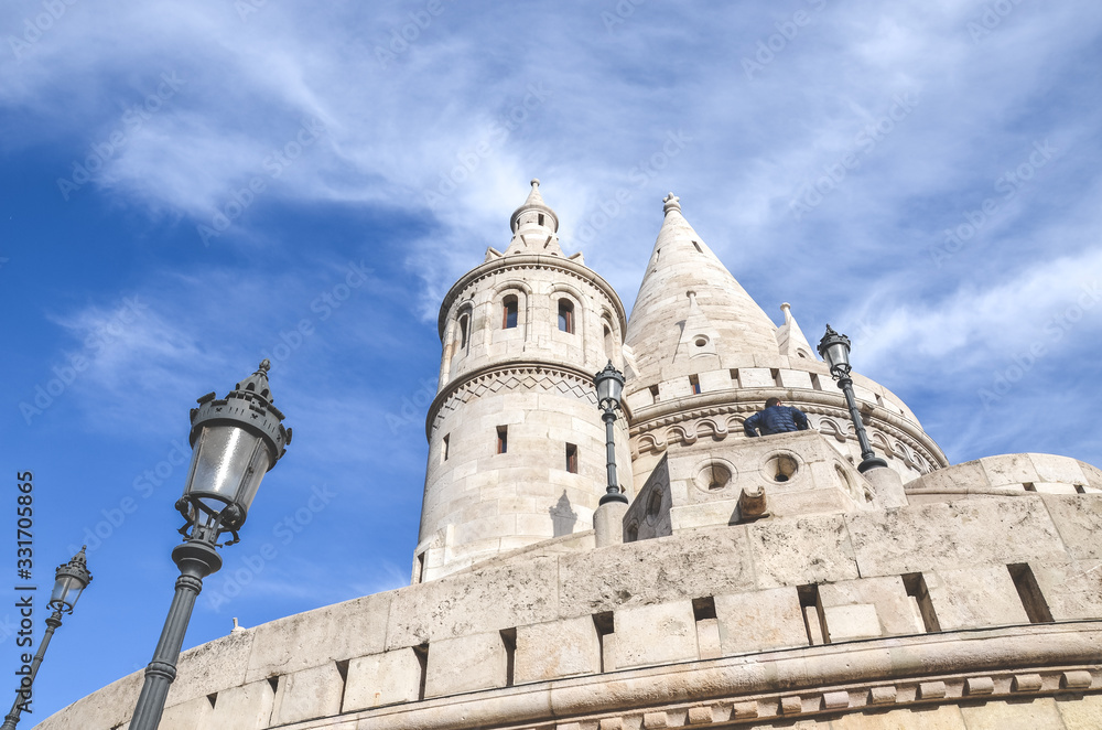 Fishermans Bastion in Budapest, Hungary. Major tourist attraction of the Hungarian capital city. Fairy tale monument, built in Neo-Romanesque style. Photographed from below, blue sky above