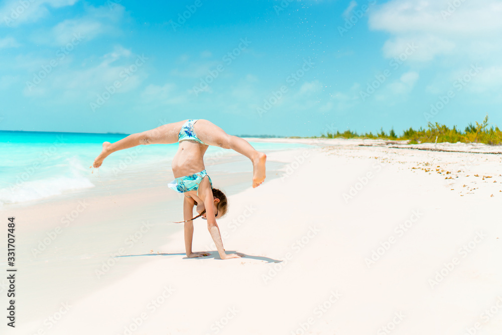 Adorable happy little girl have fun on beach vacation