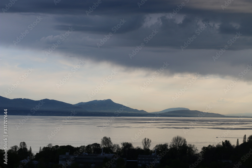 View of the Leman lake silver with rainy clouds