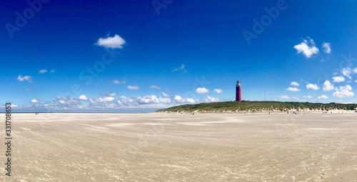 Obraz na płótnie lighthouse at the beach against blue sky