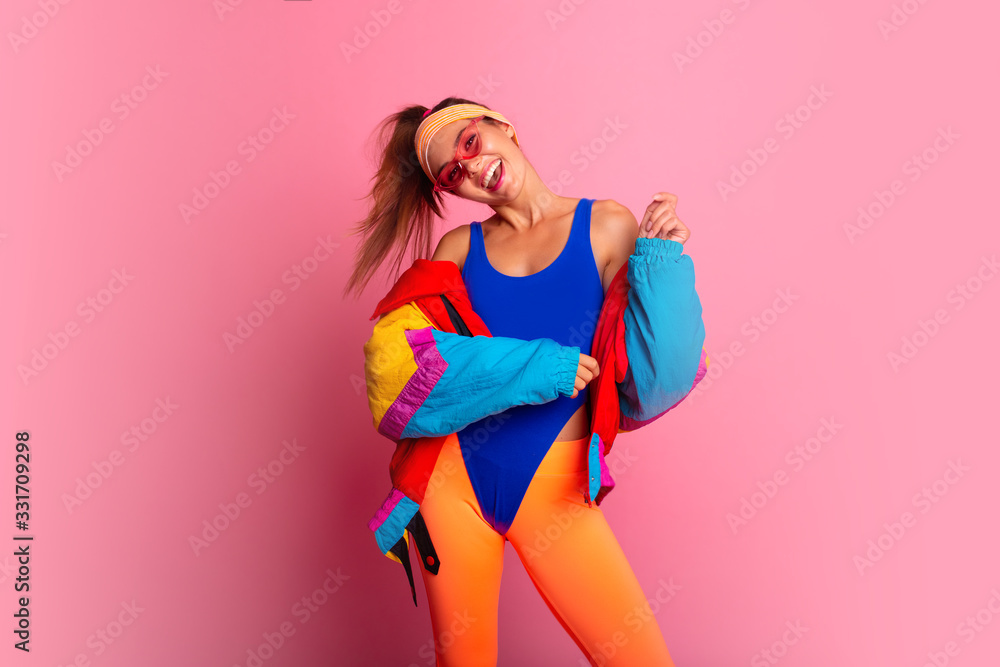 Back in time 90s 80s. Stylish girl in retro jacket and vintage aerobic body  jump suit dancing, fashion trends, entertainment, heat in summer. Happy and  positive. Horizontal, copy space. Stock Photo