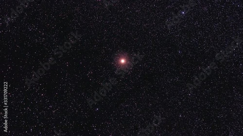 The orange star Betelgeuse in space photo