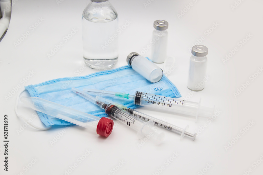 On the table are medical items and injection syringes. Medicine concept against white background