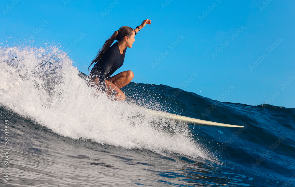 Female surfer on a wave