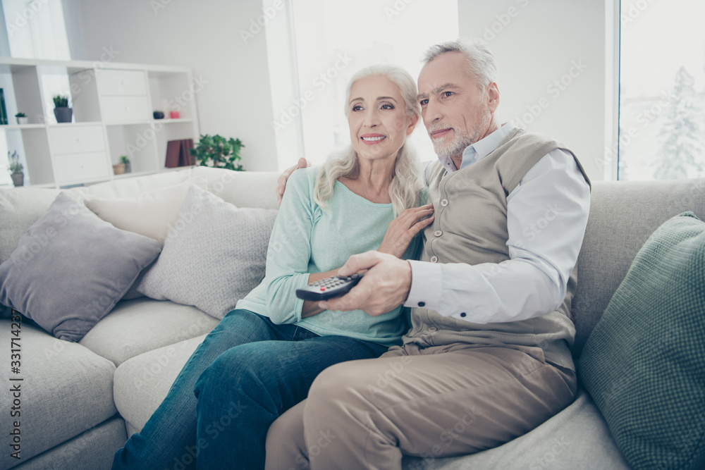 Photo of pair aged people spend free time together house session of watching romantic comedy sitting sofa