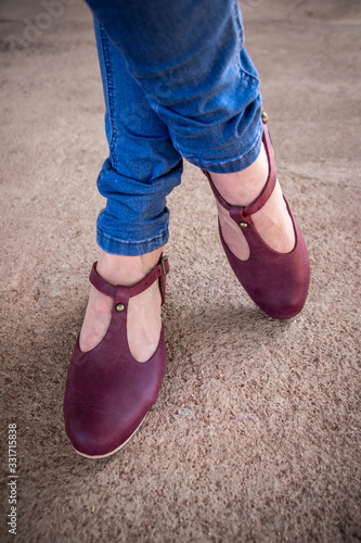 Isolated purple leather shoes on gravel