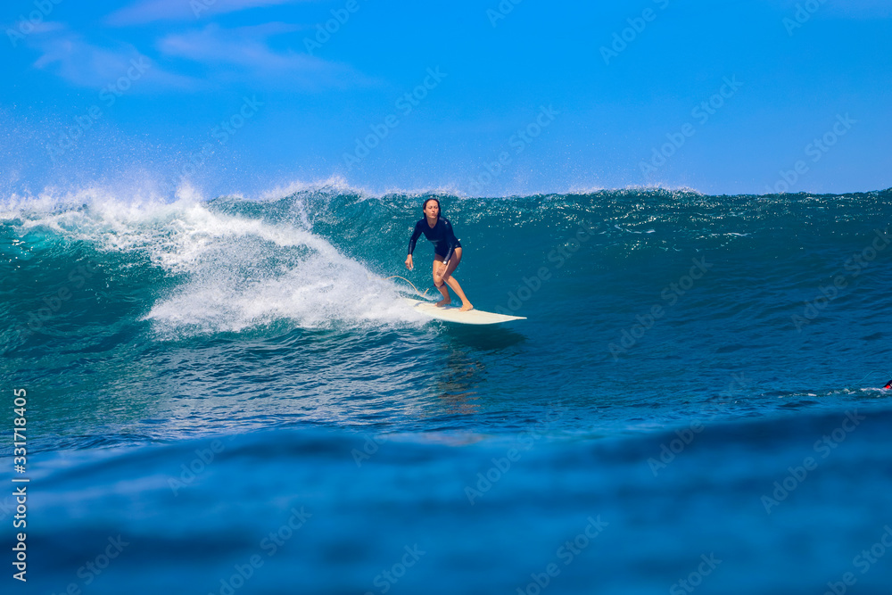 Female surfer on a wave