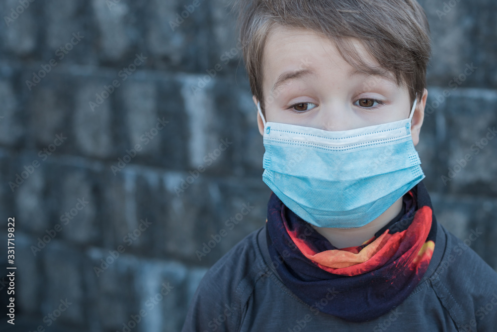 Toddler child wearing medical mask. A boy wearing mouth mask against pandemic. Concept of coronavirus quarantine or covid-19. Protection against virus and infection control concept. Toddler child wearing medical mask. A boy wearing mouth mask against pandemic. Concept of coronavirus quarantine or covid-19. Protection against virus and infection control concept.