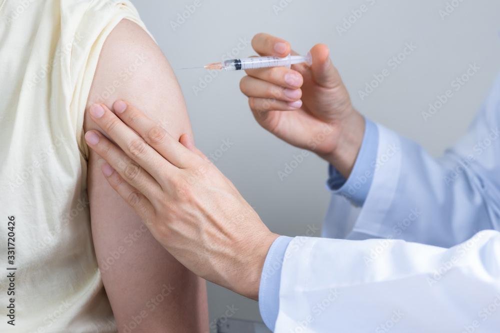 Asian man get coronavirus, flu and measles vaccine shot, vaccination in hospital for good heath, medicine injection vial dose for treatment patient. (select focus) Asian man get coronavirus, flu and measles vaccine shot, vaccination in hospital for good heath, medicine injection vial dose for treatment patient. (select focus)