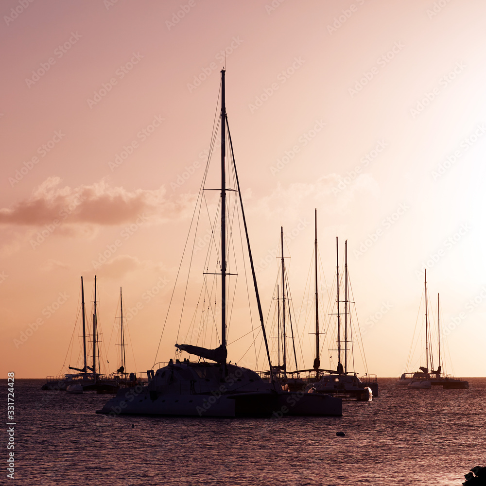 Yachts in the Bay. Silhouettes of yachts at sunset.