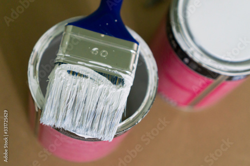 Photos Dirty paintbrush sitting over a opened can with paint