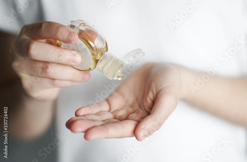 the child uses a small jar of hand sanitizer against bacteria and viruses. Personal hygiene concept. Coronavirus protection. Close up