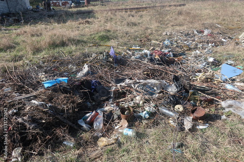 public trash dumped in a public place on gray earth