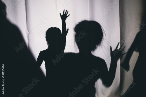 Children's silhouettes on a white background. The concept of children's problems and child protection photo