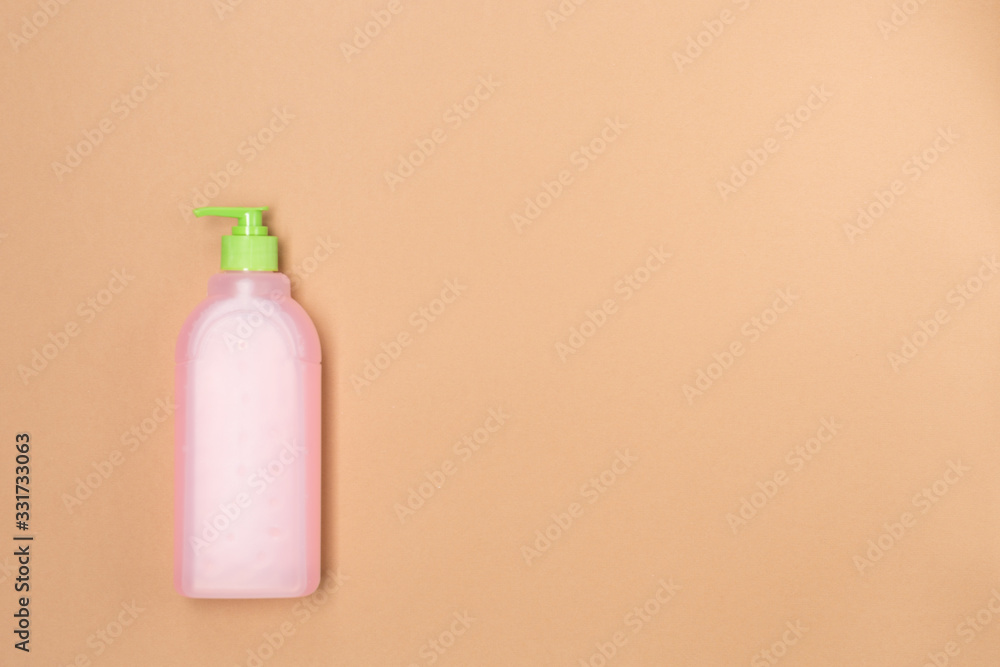 Plastic bootle of liquid soap shampoo with dispenser, closeup, isolated in beige background. Free space. Washing hands Plastic bootle of liquid soap shampoo with dispenser, closeup, isolated in beige background. Free space. Washing hands
