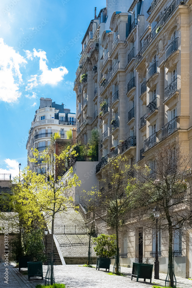 Naklejka premium Paris, romantic staircase in Montmartre, typical buildings