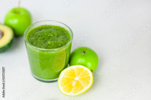 Healthy vegan green smoothie with apple, spinach, lemon. trend detox for a healthy lifestyle, weight loss, ketone diet, raw food diet
