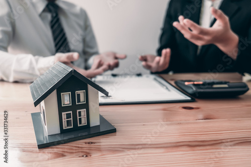 Customer signs the house insurance contact after listening the contact agreement from agent.