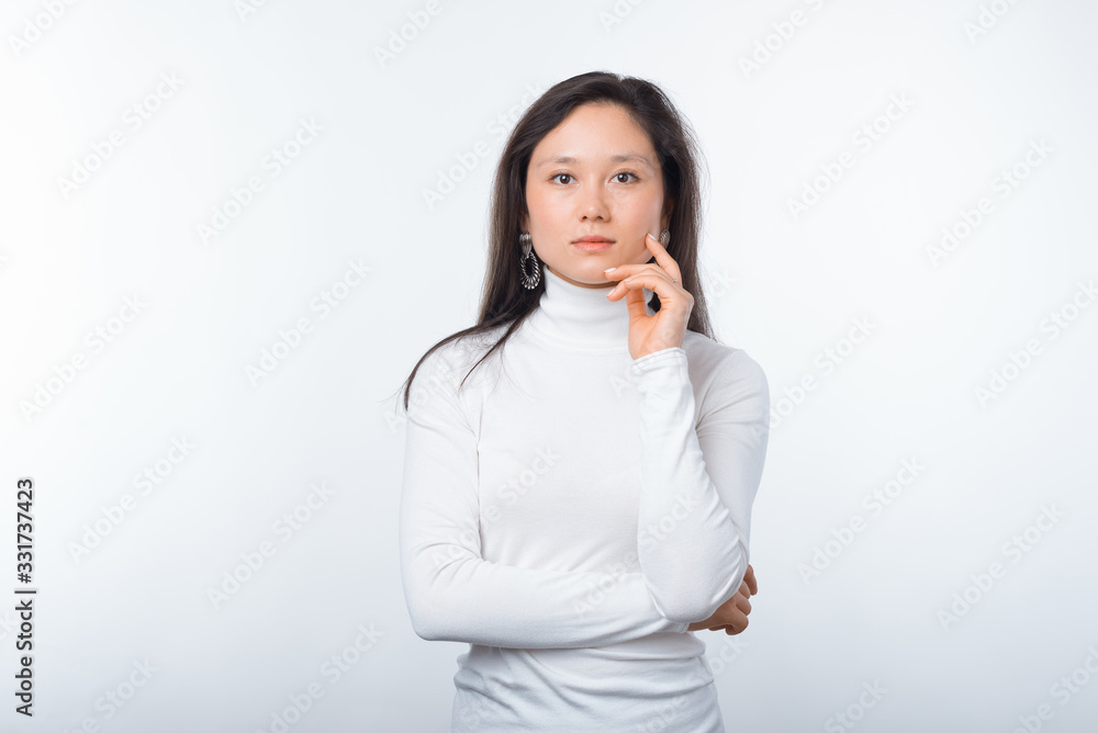 Portrait of young woman in casual standing over white background with crossed arms and looking confident at the camera Portrait of young woman in casual standing over white background with crossed arms and looking confident at the camera