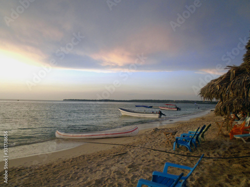 Boats on the beach at caribbean sunset