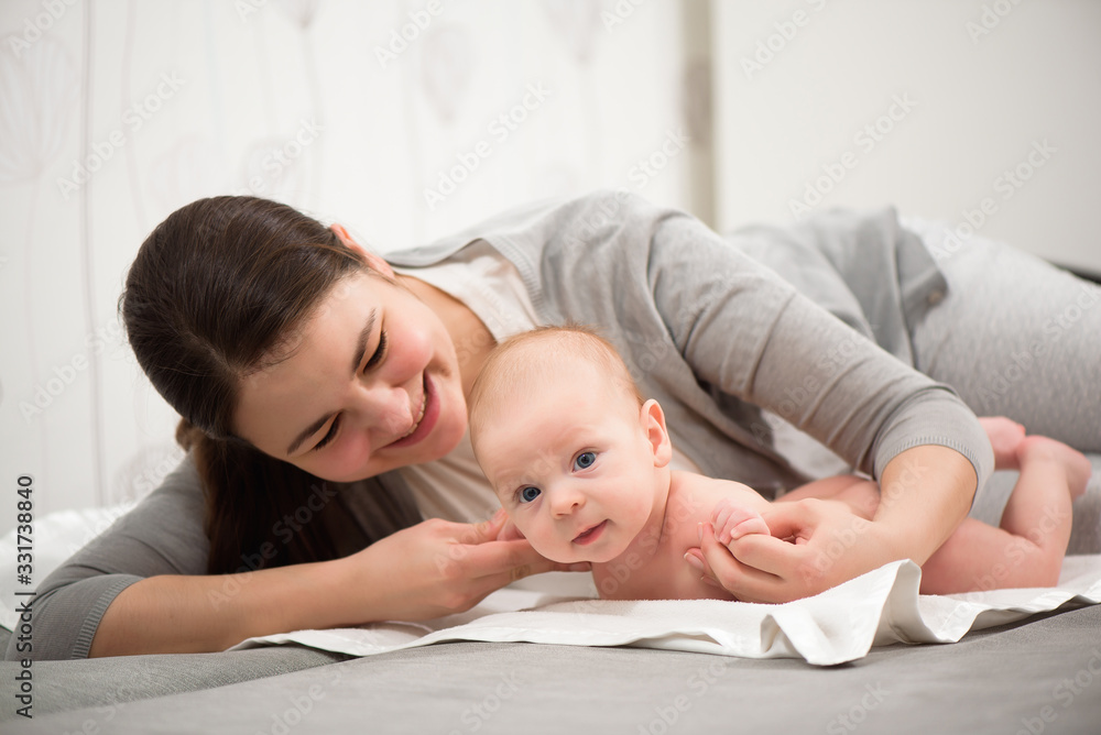 Happy family. Mother playing with her baby in the bedroom. Happy family. Mother playing with her baby in the bedroom.