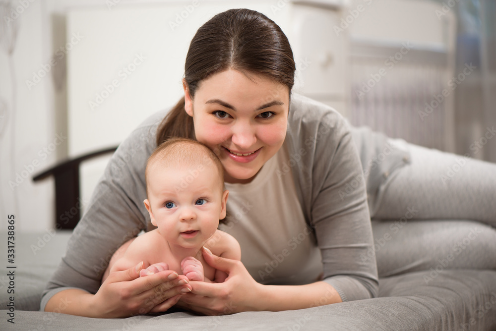 Young mother holding her baby in the bedroom. Young mother holding her baby in the bedroom.