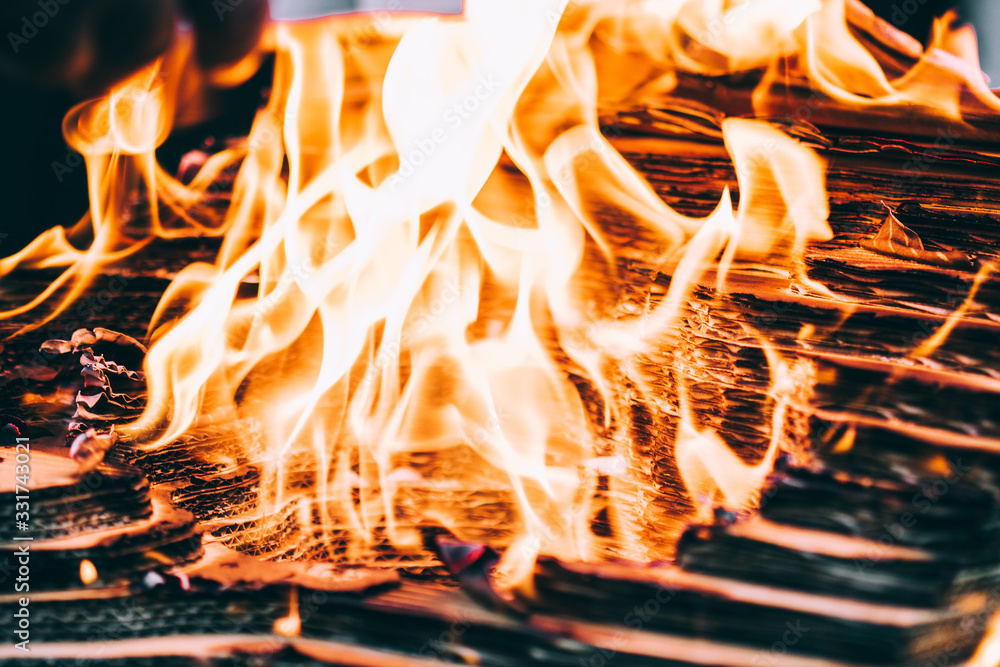 Fototapeta premium A photograph of the flames engulfing a cardboard architectural model.