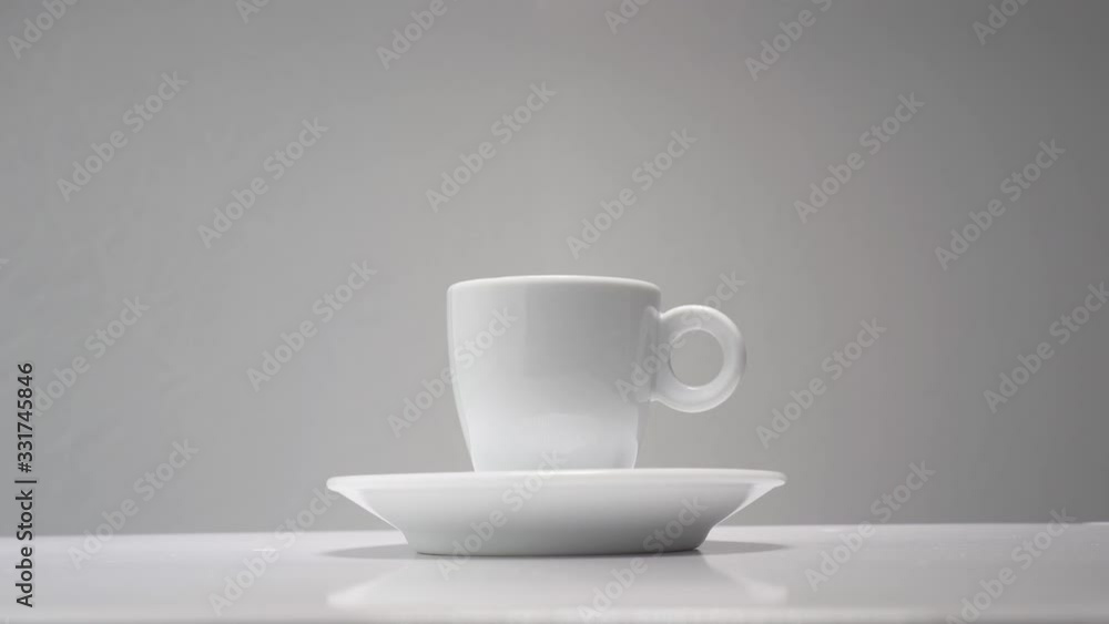 Steam rises from a cup of hot coffee. Grey background Steam rises from a cup of hot coffee. Grey background