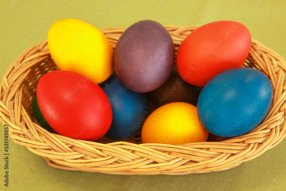 Easter eggs colors in basket green background Easter eggs colors in basket green background