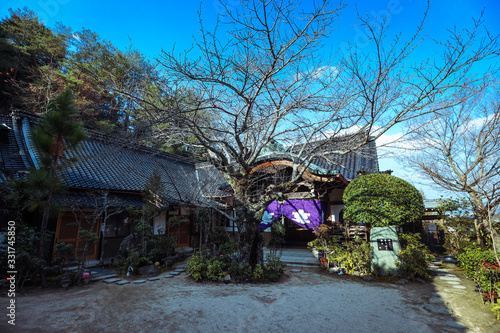 Miyajima, Japan - January 02, 2020: Cityscape to the Walking Tourists and  Itsukushima streets © Dave