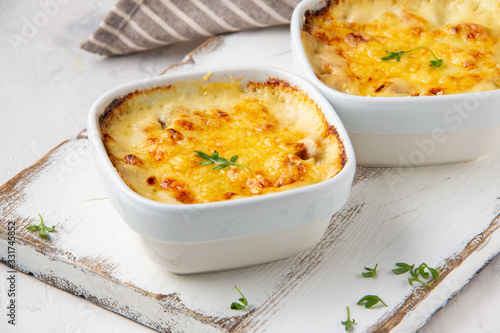 Fotografija Casserole with a golden crust , mushroom julienne with baked cheese, creamy gratin