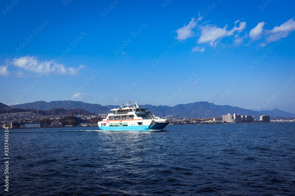 Naklejka premium Miyajima, Japan - January 02, 2020: Ferry Boat to Itsukushima Shrine