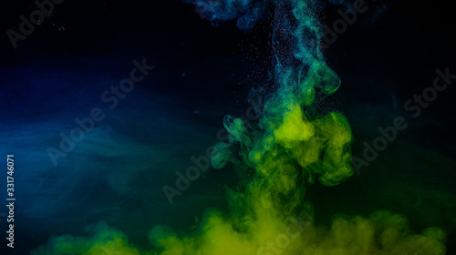 Color drop in water on black background © Aditya