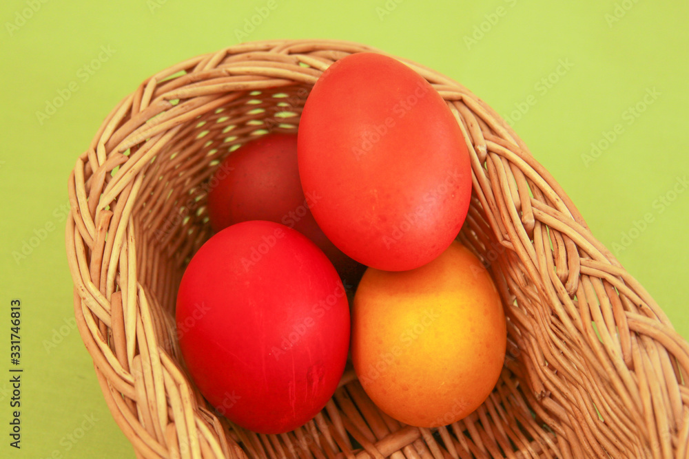 Naklejka premium Easter eggs in basket warm colors