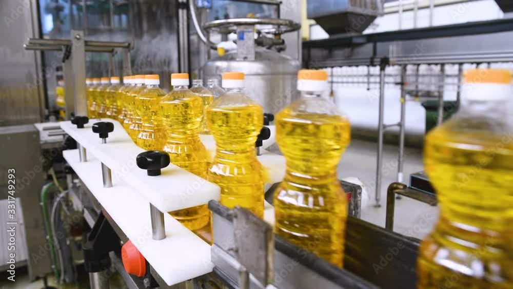 Sunflower oil in the bottle moving on production line. Sunflower oil production factory Sunflower oil in the bottle moving on production line. Sunflower oil production factory