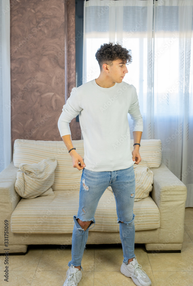 Young man posing on a living room sofa Young man posing on a living room sofa