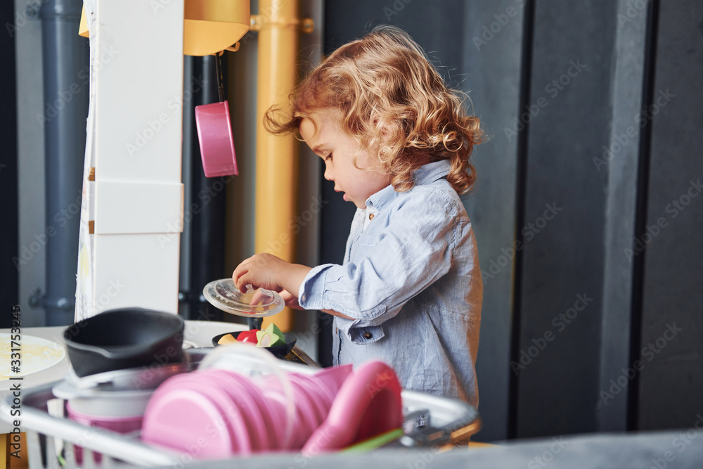 Child in casual clothes have fun by learning how to prepare food Child in casual clothes have fun by learning how to prepare food