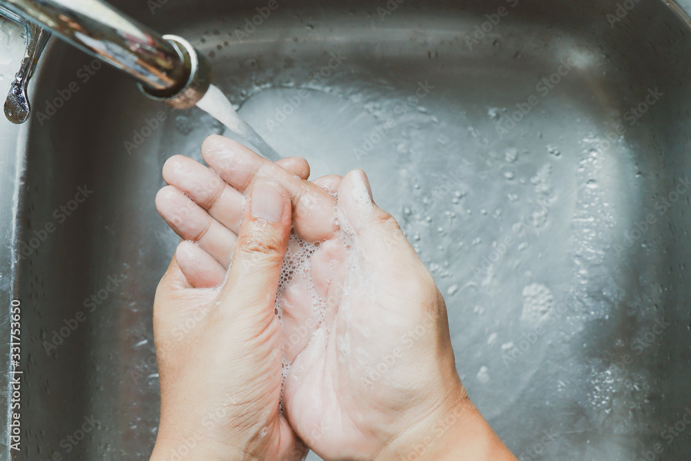 Fototapeta premium washing hands at the sink in kitchen