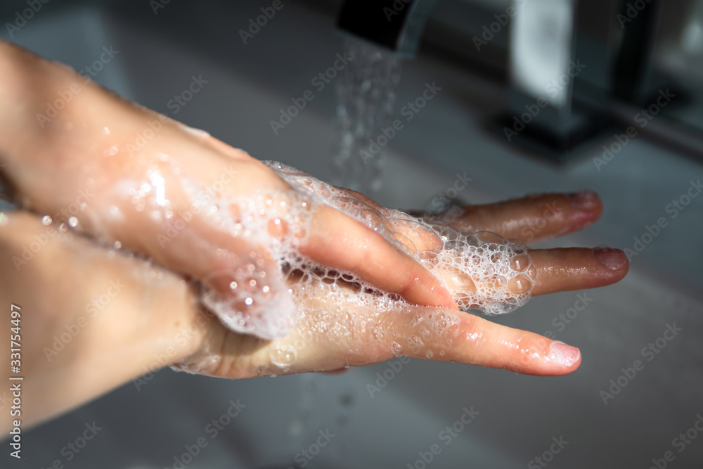 Fototapeta premium washing hands with soap and water