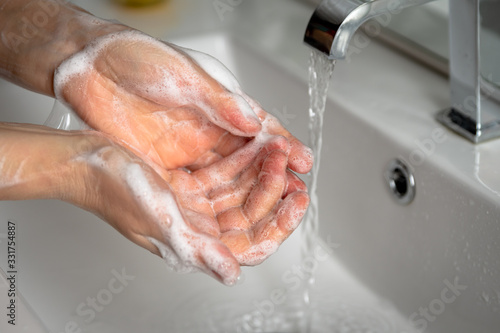 woman washing her hands in the bathroom