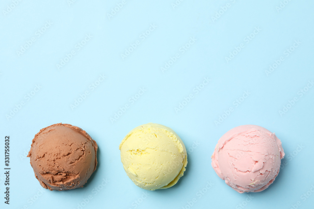Ice cream balls on blue background, space for text Ice cream balls on blue background, space for text