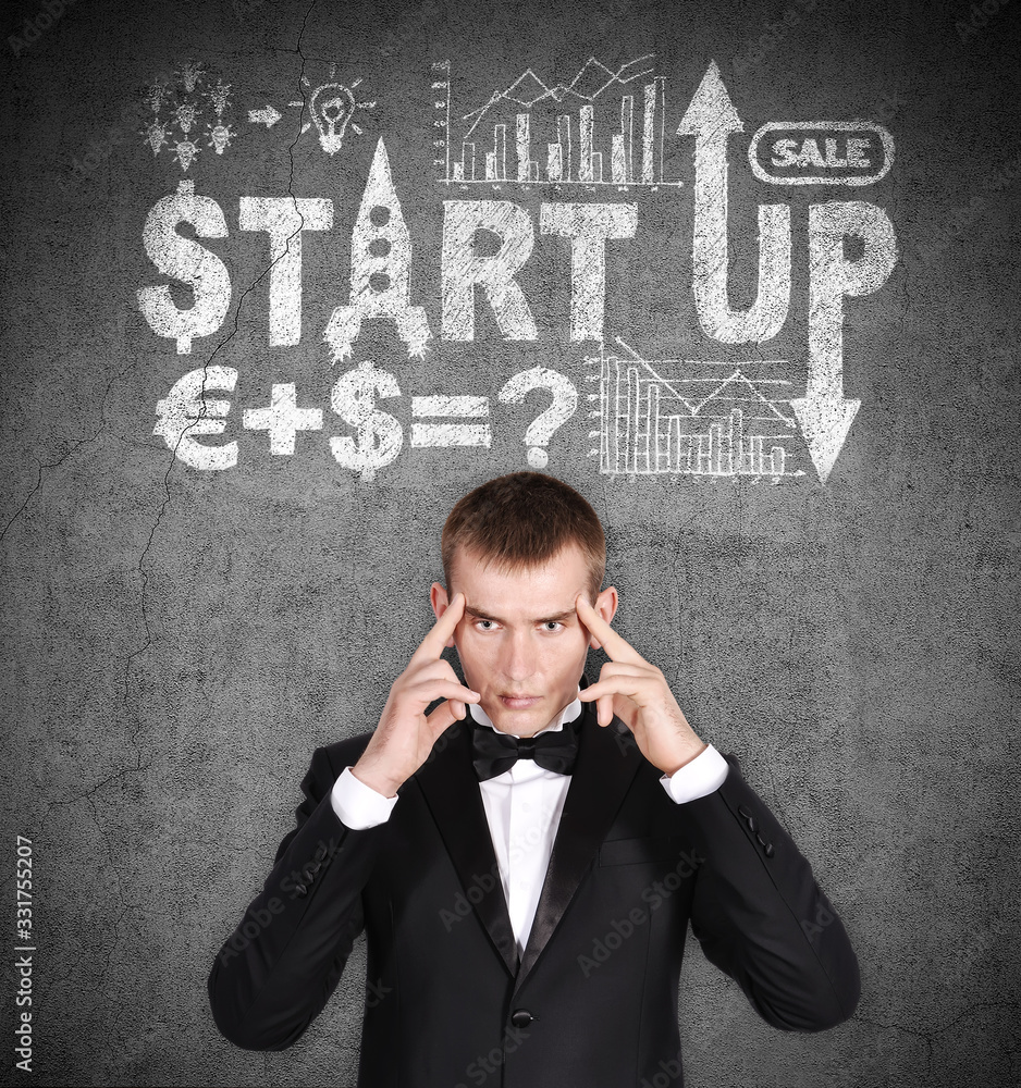 Pensive businessman with drawing start up scheme Pensive businessman with drawing start up scheme