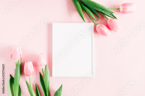 Fototapeta Naklejka Na Ścianę i Meble -  Flowers composition romantic. Blank frame for text, pink tulips on pastel pink background. Flat lay, top view, copy space