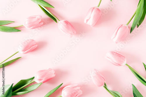 Fototapeta Naklejka Na Ścianę i Meble -  Flowers composition romantic. Pink tulips on pastel pink background. Flat lay, top view, copy space