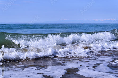  Waves with foam close up on a tropical sandy beach. Copy space for background